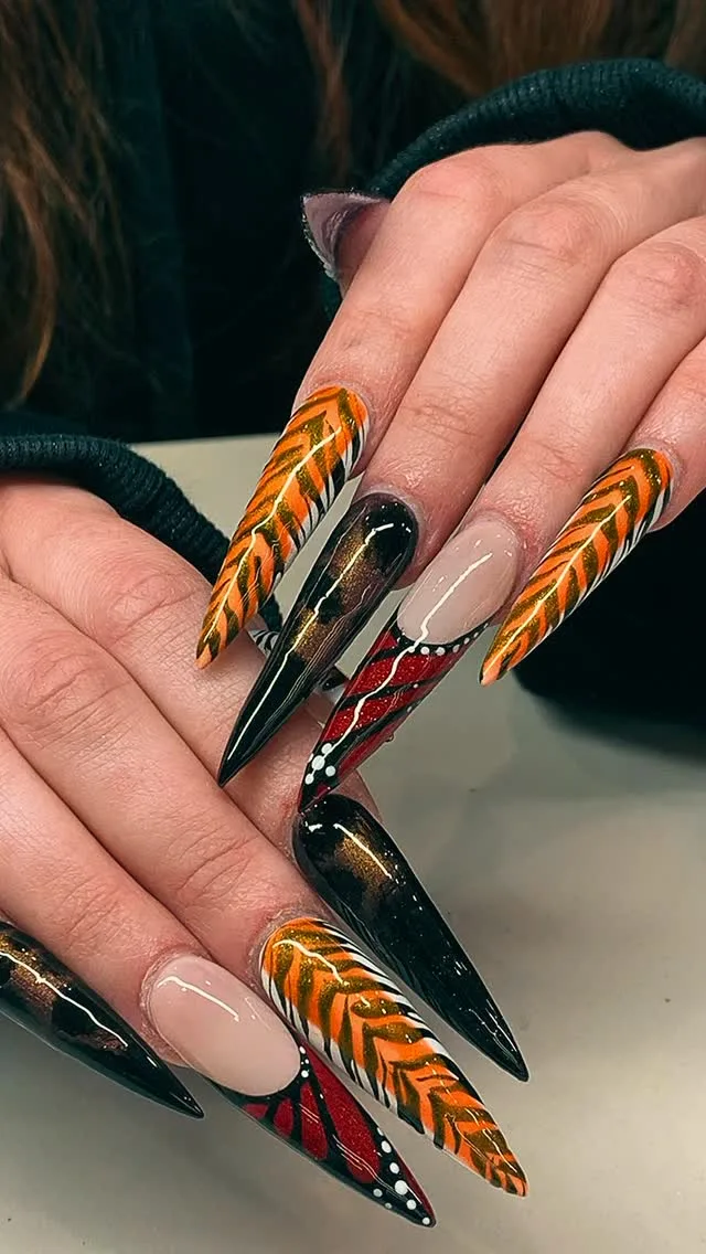 Orange feather and tiger stiletto nails
