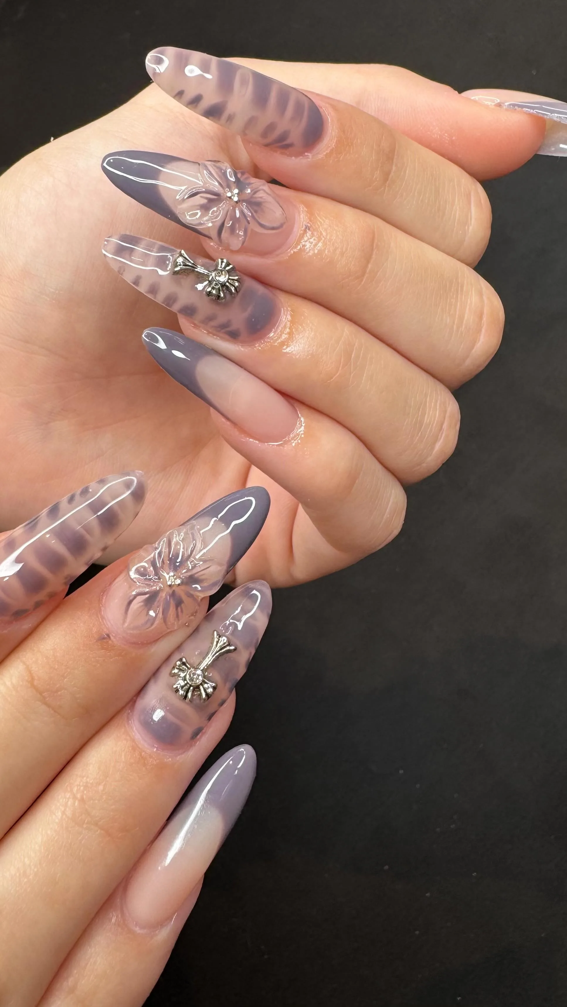 Marble grey-lavender nails with sculpted 3D flower and rhinestone charm