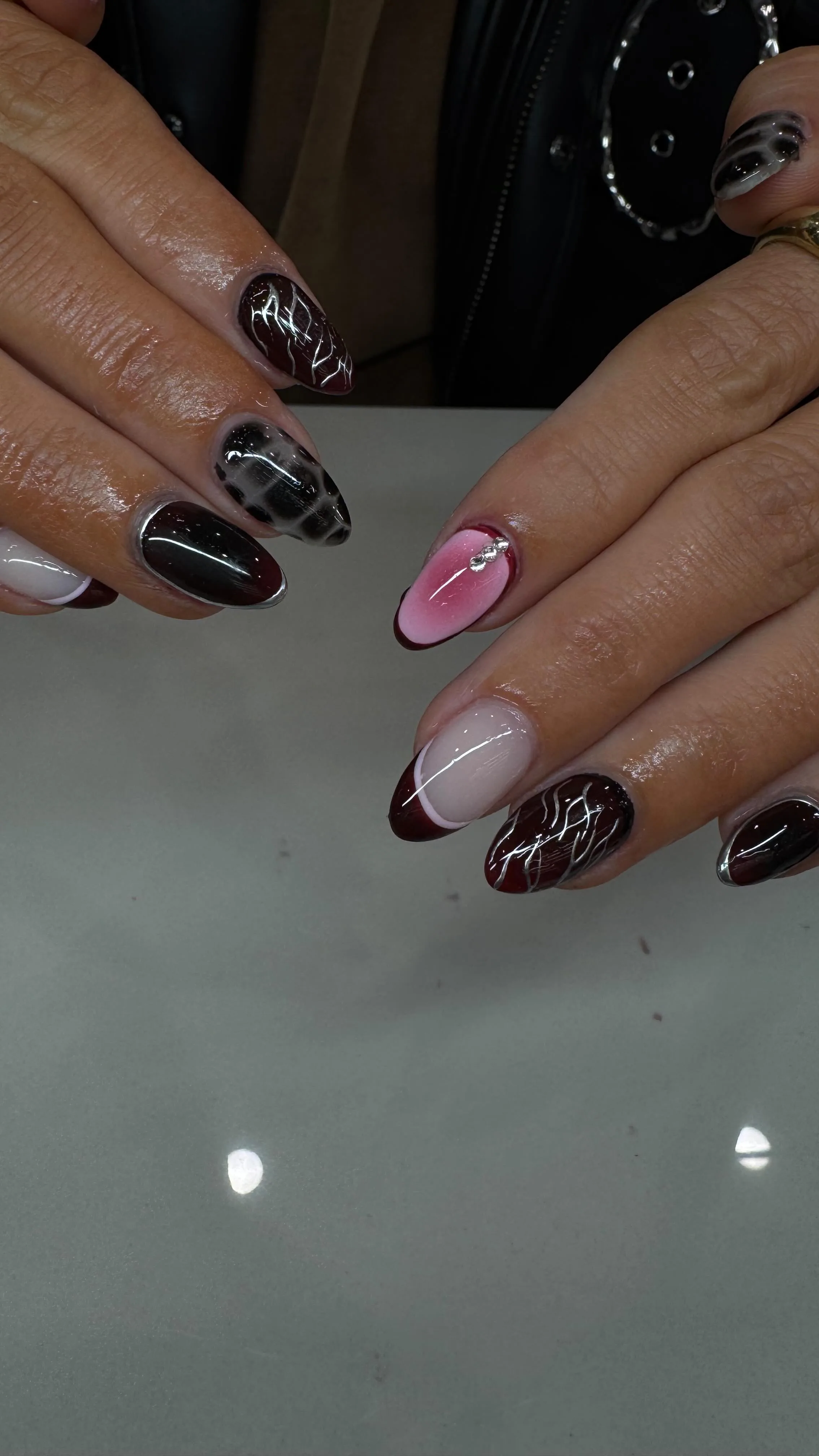 Burgundy chrome nails with silver wire art — bespoke nail work at Pure Nails & Lashes